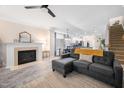 Open-concept living room with a fireplace, a plush sofa, and modern flooring at 992 Ambergate, Apex, NC 27502