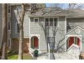 Neutral-toned townhouse features a charming red front door with a wreath accent at 100 Hunting Chase # 1-B, Cary, NC 27513