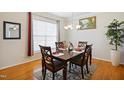 Elegant dining room with hardwood floors, a chandelier, and ample natural light at 101 Whitney Ln, Durham, NC 27713