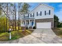 Beautiful two-story home with a well-kept lawn, two-car garage, and inviting front porch at 101 Whitney Ln, Durham, NC 27713