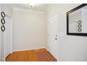 Bright foyer featuring hardwood floors, crown molding, and a stylish mirror at 101 Whitney Ln, Durham, NC 27713