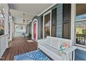 Relaxing front porch featuring a bench, patterned rug, and a charming outdoor seating area at 111 Parkside Cir, Chapel Hill, NC 27516