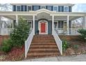 Inviting front porch with brick steps and a striking red front door at 111 Parkside Cir, Chapel Hill, NC 27516