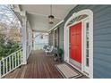 Charming covered front porch with rocking chairs and a red front door at 111 Parkside Cir, Chapel Hill, NC 27516