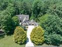 Expansive property surrounded by dense woodlands, featuring a long driveway leading to a custom-built home at 12117 Cliffside Cir, Raleigh, NC 27614