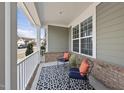 Relax on this cozy front porch with comfortable seating, offering a perfect spot to enjoy the outdoors at 1212 Stonemill Falls Dr, Wake Forest, NC 27587