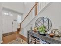Welcoming foyer featuring hardwood floors, a stylish console table, and staircase leading to the upper level at 123 Carbone Ln, Clayton, NC 27527