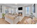 Cozy living room with a fireplace, large windows, and comfortable seating at 123 Carbone Ln, Clayton, NC 27527