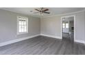 Bright living room features fresh paint, vinyl floors, and a ceiling fan at 1239 Brogden Rd, Smithfield, NC 27577