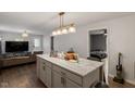 Open kitchen featuring a large center island with marble countertops and modern pendant lighting at 1304 Drew St, Durham, NC 27701