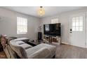 Cozy living room featuring gray walls, a comfortable sectional sofa, and natural light at 1304 Drew St, Durham, NC 27701