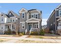 Attractive gray home with well-manicured landscaping, inviting entrance, and a cozy front porch at 1312 Big Falls Dr, Wendell, NC 27591