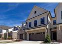 Lovely townhome with a brick and siding facade, two-car garage, and attractive landscaping at 163 Periwinkle Pl, Clayton, NC 27527