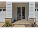 Inviting front porch featuring a gray trim and door and brick accents at 175 Norwell Ln, Pittsboro, NC 27312