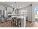 Modern kitchen featuring a spacious island, stainless steel appliances, and sleek gray cabinets at 175 Norwell Ln, Pittsboro, NC 27312