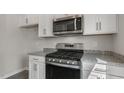 Modern kitchen with stainless steel appliances and gray granite countertops at 176 Starlight St, Sanford, NC 27330