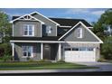 Charming two-story home with gray siding, stone accents, a two car garage, and professionally landscaped yard at 18 Tuskeegee Dr, Smithfield, NC 27577