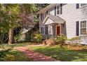 Charming two-story home with manicured lawn and brick pathway at 212 W University Dr, Chapel Hill, NC 27516