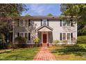 Charming two-story home with a brick pathway and manicured lawn at 212 W University Dr, Chapel Hill, NC 27516