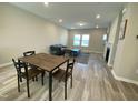 Open concept living area with a fireplace, a dining table, and comfortable seating at 219 Adobe Pl, Cary, NC 27519