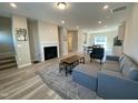 Spacious living room featuring modern furniture, a cozy fireplace, and beautiful flooring, perfect for entertaining at 219 Adobe Pl, Cary, NC 27519