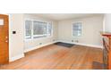 Bright living room showcasing hardwood floors and large windows for natural light at 2246 Hillandale Rd, Durham, NC 27705