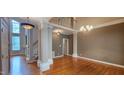 Spacious living room with hardwood floors, abundant light, and decorative lighting at 2429 Falls River Ave, Raleigh, NC 27614