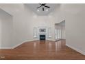 Spacious living room with high ceilings, fireplace, and gleaming hardwood floors at 2505 Egypt Mountain Rd, Kittrell, NC 27544