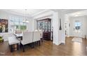 Bright dining room featuring hardwood floors, large windows, elegant furniture, and stylish decor at 251 North Crest Dr, Chapel Hill, NC 27517