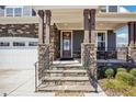 Inviting front porch with stone accents, sturdy columns, and iron railings leading to the front door at 251 North Crest Dr, Chapel Hill, NC 27517
