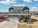 Inviting two-story home boasting a stone-accented garage, covered porch, and well-manicured lawn at 251 North Crest Dr, Chapel Hill, NC 27517