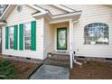 Welcoming front entrance with bright green shutters, a decorative door, and a well-kept small garden at 2776 Jordan Ct, Creedmoor, NC 27522