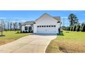Well-maintained one-story home with a two-car garage, neat landscaping, and a long concrete driveway at 28 Sandcastle Ln, Four Oaks, NC 27524