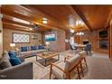 Spacious living room with wood paneled ceiling, brick walls, and a cozy fireplace at 3001 Blanche Dr, Burlington, NC 27215