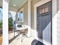 Cozy front porch with seating area and stylish front door at 3162 Retama Run # 231, Apex, NC 27562