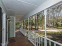 Inviting covered porch with wood flooring and white railings, perfect for relaxing outdoors at 3313 Ventura Cir, Wake Forest, NC 27587