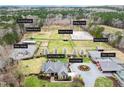 Stunning aerial view of an estate with horse pastures, riding arena, and well-manicured grounds at 3417 Pea Ridge Rd, New Hill, NC 27562