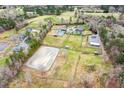 Expansive estate aerial featuring a home, horse pastures, riding arena, and outbuildings at 3417 Pea Ridge Rd, New Hill, NC 27562