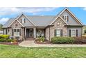 Charming stone and wood home featuring a welcoming front porch and lush landscaping at 3417 Pea Ridge Rd, New Hill, NC 27562