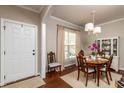 Inviting dining room boasts hardwood floors, a decorative rug, and a view of the bright outdoors at 345 Anterbury Dr, Apex, NC 27502