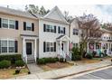 Attractive townhome showcasing a neat front garden, sidewalk, and pleasing architectural details at 345 Anterbury Dr, Apex, NC 27502