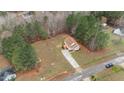 Expansive aerial view of a cozy home surrounded by lush greenery, highlighting the property's privacy and serene setting at 35 Flume Rd, Franklinton, NC 27525