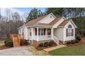 Charming one-story home with a welcoming front porch and a deck, showcasing a blend of traditional and inviting features at 35 Flume Rd, Franklinton, NC 27525