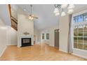 Spacious living room with vaulted ceilings, fireplace, large windows, and hardwood floors at 4117 Olde Coach Rd, Durham, NC 27707