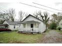 Cozy white bungalow with welcoming front porch and gravel driveway at 423 E Rockspring St, Henderson, NC 27536