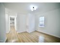 Bright living room with new hardwood flooring and a large window at 423 E Rockspring St, Henderson, NC 27536