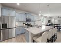 Modern kitchen featuring a large island, stainless steel appliances, and stylish blue cabinets at 508 Sweet Pine Ln, Knightdale, NC 27545