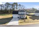 Beautiful home showcasing a spacious yard surrounded by mature trees at 54 Silverleaf Dr, Wendell, NC 27591