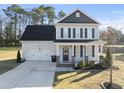 Inviting two-story home featuring a covered porch, well-kept lawn, and attached garage at 54 Silverleaf Dr, Wendell, NC 27591