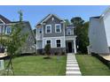 Charming two-story home with stone accents and well-maintained landscaping and covered front entryway at 5648 Cayden Cove Dr, Wendell, NC 27591